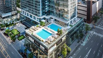 An aerial view of a building with a pool on top of it